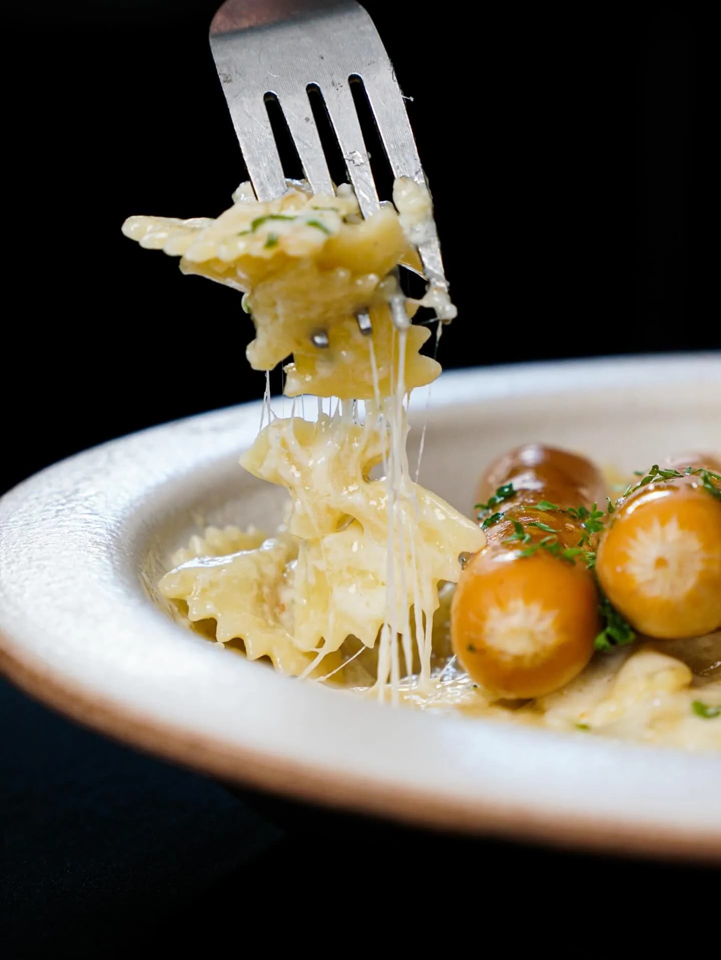 Pasta with cheese and sausages; official CHOMP Kitchen photo, not attributed to a specific branch