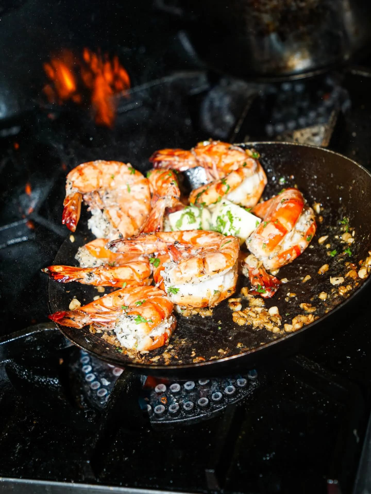 Prawns with herbs and garlic in a pan; official CHOMP Kitchen photo, not attributed to a specific branch