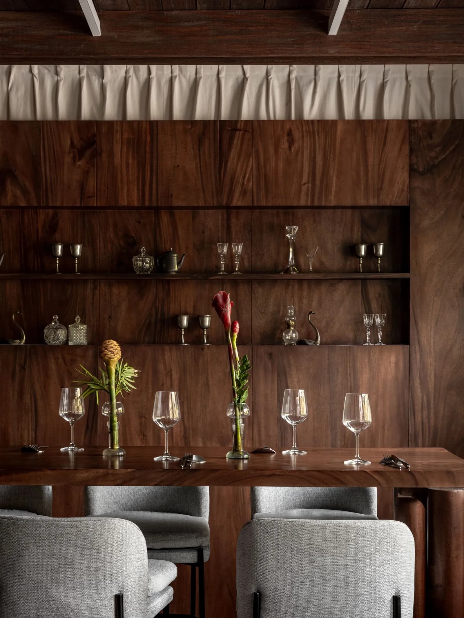 A set wooden table and upholstered chairs at Brie Restaurant & Cheesery